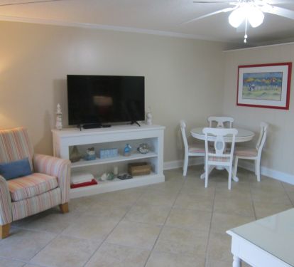 Living room area with 55" Smart TV and eating area.