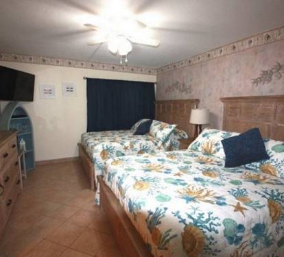 bedroom with 2 queen size beds and large dresser for clothing storage