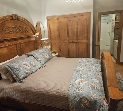 2nd King bedroom w 2 nightstands, wall mirrors, lamps and a tall drawer dresser