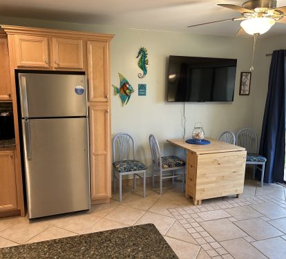 Kitchen table will seat 4, new 55" Smart TV in combination living room/kitchen