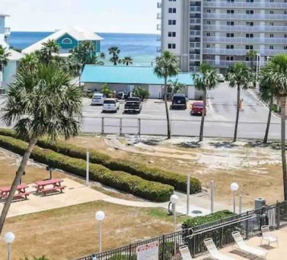 View of walkway to beach. walk between hedges, along side of vinyl fence to beach. All gated for condo guests.