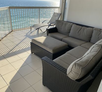 Large gulfside balcony features outdoor sectional sofa.