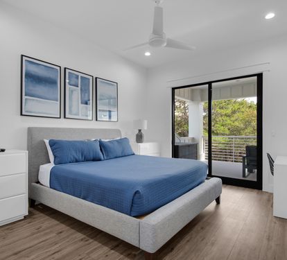 King Bedroom with a desk and chair and glass doors to second floor patio