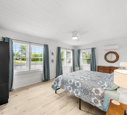 Large king bedroom filled with natural light