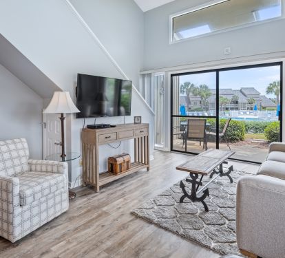 Ground floor end unit has walk out to pool