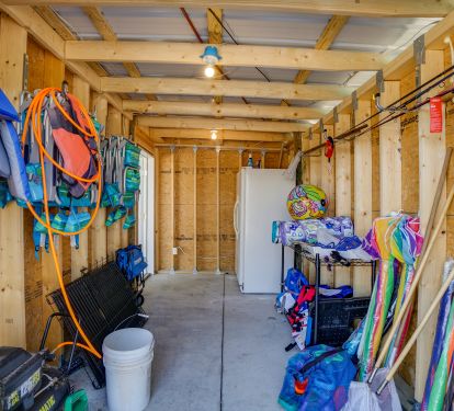 Our beach gear storage. Air compressor, kennels, rods, toys, games, nets, boards