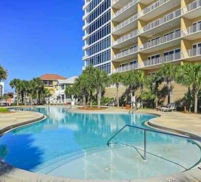 Tropical Lagoon Pool with Community Grilling Area and Seating