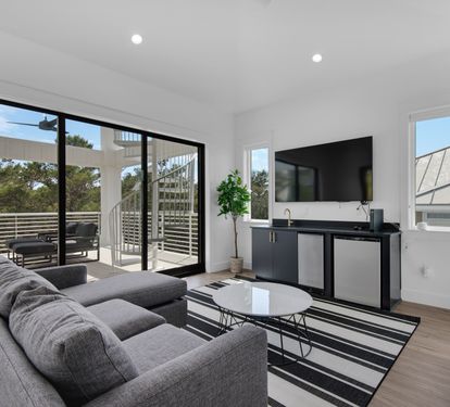 Living room in second floor w/ a 70&rdquo; TV, wet bar sink, ice machine &amp; mini fridge