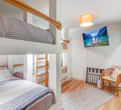 Bunk room has a spacious closet with beach chairs, games, and books.