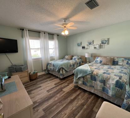 The second bedroom offers 2 full size beds, dresser and flat screen tv.