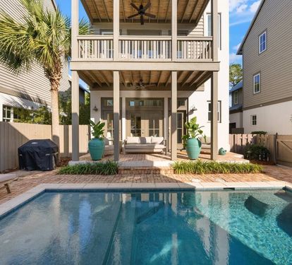 Palms, pavers, ceiling fans, and a pool made for all-day lounging