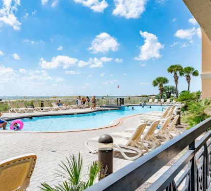 Ground-floor walk-out patio just steps from the pool and beach access