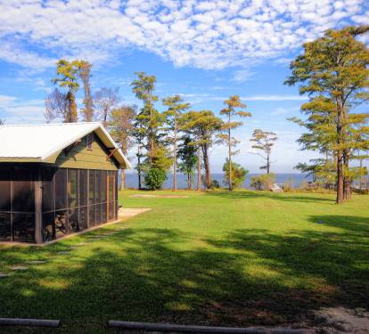 View of the house and the bay from the Little House by the Bay driveway