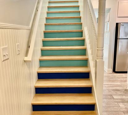 Follow the colorful stairs to the living room and enjoy the stunning gulf view