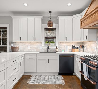 Commercial sink, double oven, gas range. Coffee Pot, and Keurig.