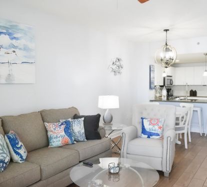 Newly refurnished and redecorated Living Room adjacent to the Dining area that includes a dining table with seating for 4 and 4 barstools