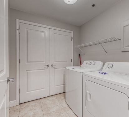 Full size Laundry Area with storage closet