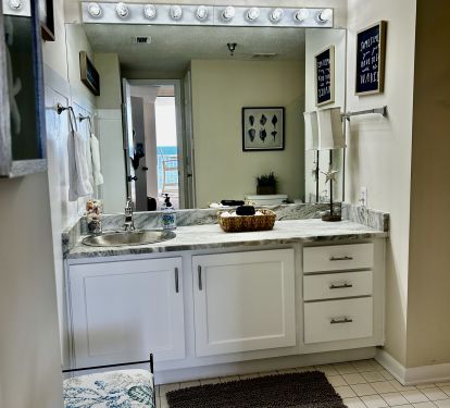 Large Master Bath with newly remodeled cabinets and granite countertop.
