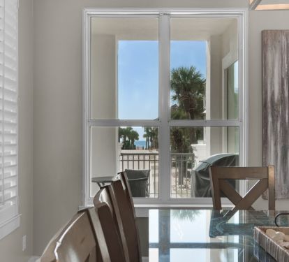 VIEW OF OCEAN, GRILL AND TABLE ON PATIO FROM MAIN FLOOR DINING TABLE 