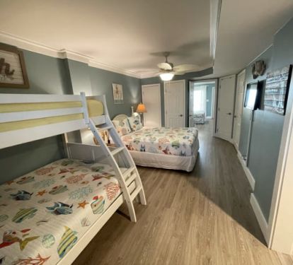 Family lower level front bedroom: queen bed,new twin over full bunk. Entryway on right