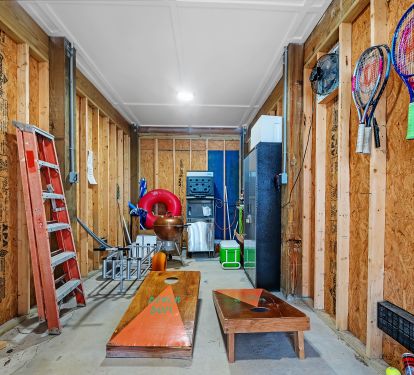 Storage room with beach wagon and commercial ice machine. Also cornhole game