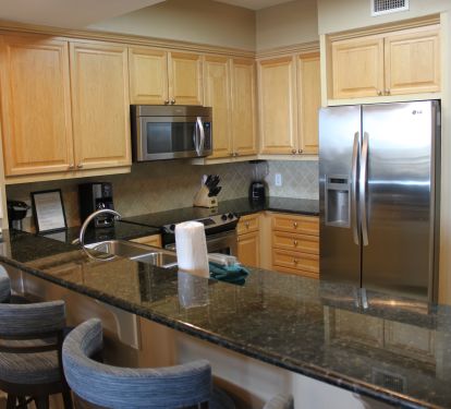 Modern, fully outfitted kitchen, with marble countertops
