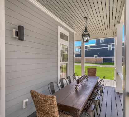 Large Outdoor Dining Table on Wrap Around Porch