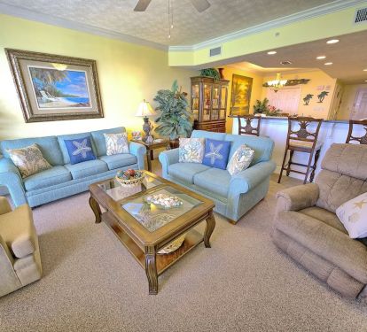 LIVING AREA FEATURES LAZYBOY RECLINER WITH VIEW OF BAR AREA.
