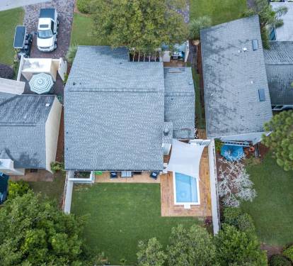 Aerial view of the home and the pool