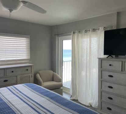 Master Bedroom with Access to Balcony and Flat Screen TV