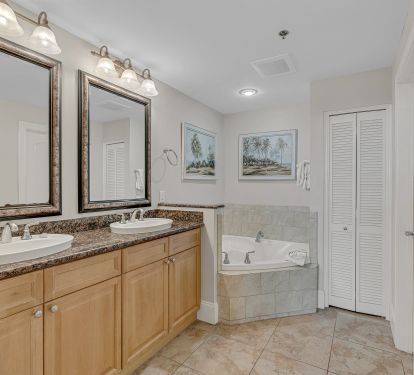 Private master bath with spacious vanity and fresh linens provided.
