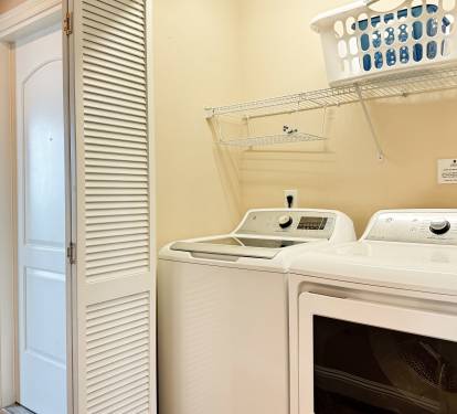 Full-size washer and dryer located inside the condo