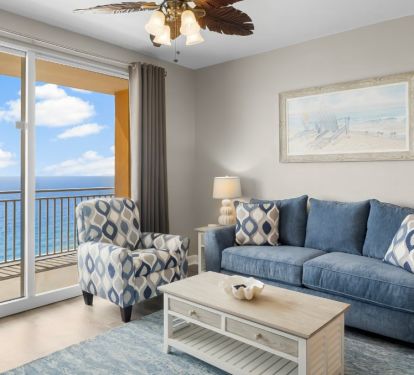 Bright coastal living room with oceanfront balcony views.