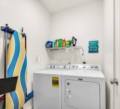 Laundry Room with Washer, Dryer, Ironing board, Iron.