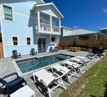 Additional view of the back yard/patio at "Sunseeker"! Complete with a 60" TV for watching the game or a family movie around the pool at nighttime!