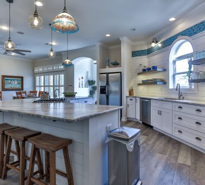 Kitchen features rare gas range with griddle burner and handy prep sink