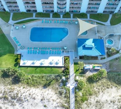 Aerial view of pool area with deck, kiddie pool and hot tub.
