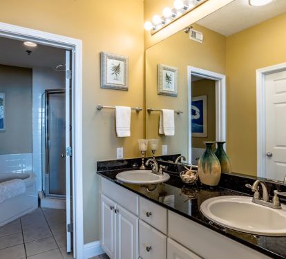 Master bathroom with walk in closet and separate sink area