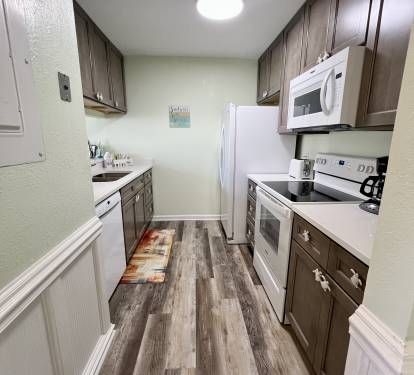 The galley kitchen is fully stocked with everything that you'll need.