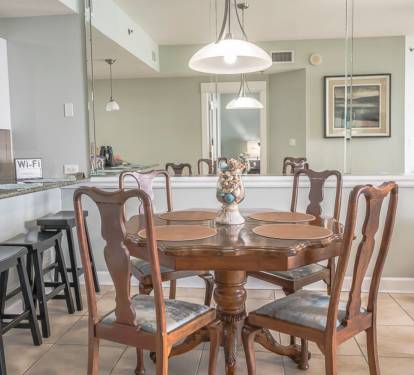 Dining area has seating for 4 at the dining table and 4 at the bar.