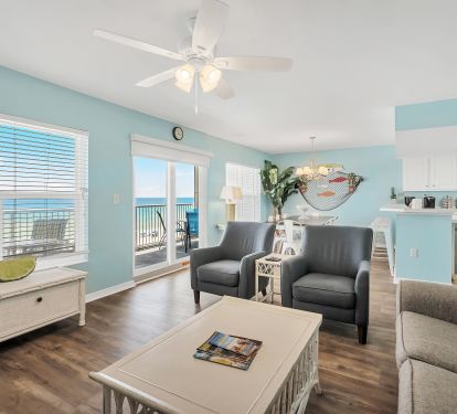 View of the beach, dining room, and kitchen from the living room.