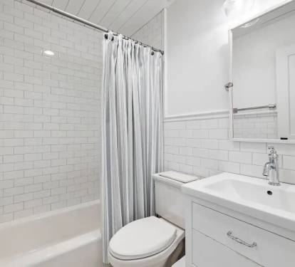 Full bath with white subway tile and marble floor 