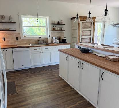 Fully equipped kitchen stocked with cookware, drink ware, silverware, and all other kitchen necessities.