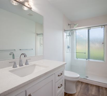 Large ensuite bathroom has walk in shower and dual vanities.