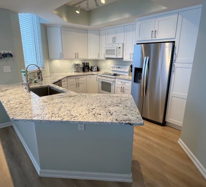 Brand new custom white shaker cabinet kitchen w/ white ice granite countertops.