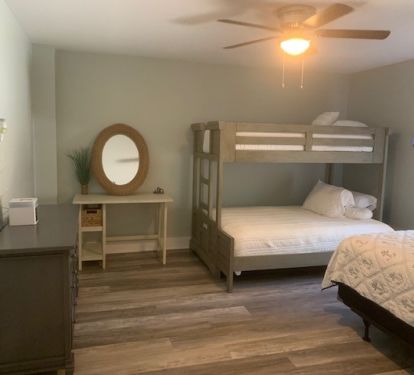 Main floor bedroom with queen bed and twin over full bunk 