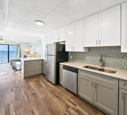 Fully stocked kitchen with beautiful tile backsplash.