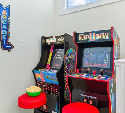 Level up the fun! ðŸŽ®âœ¨ This cozy loft space is packed with excitement, featuring two sit-down arcade games for endless hours of play. Perfect for kids and adults alike!