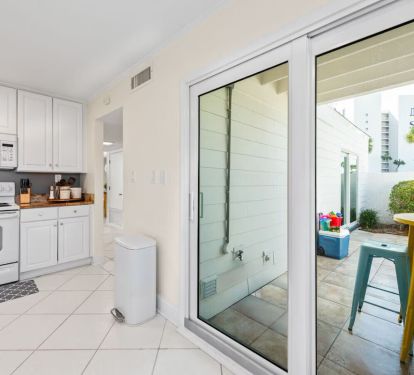 The Seabreeze Villa kitchen is bright and welcoming, featuring crisp white cabinets, marble-inspired countertops, and gold accents. Equipped with modern essentials, including a coffee station to start your mornings right. â˜•âœ¨