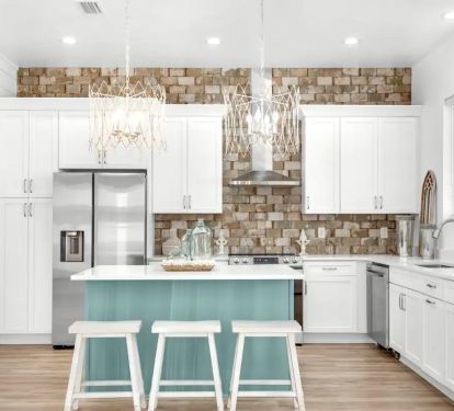 Windsong-7 Create your culinary masterpieces in Windsong's new kitchen, featuring stainless appliances with quartz counters and brick accent wall.